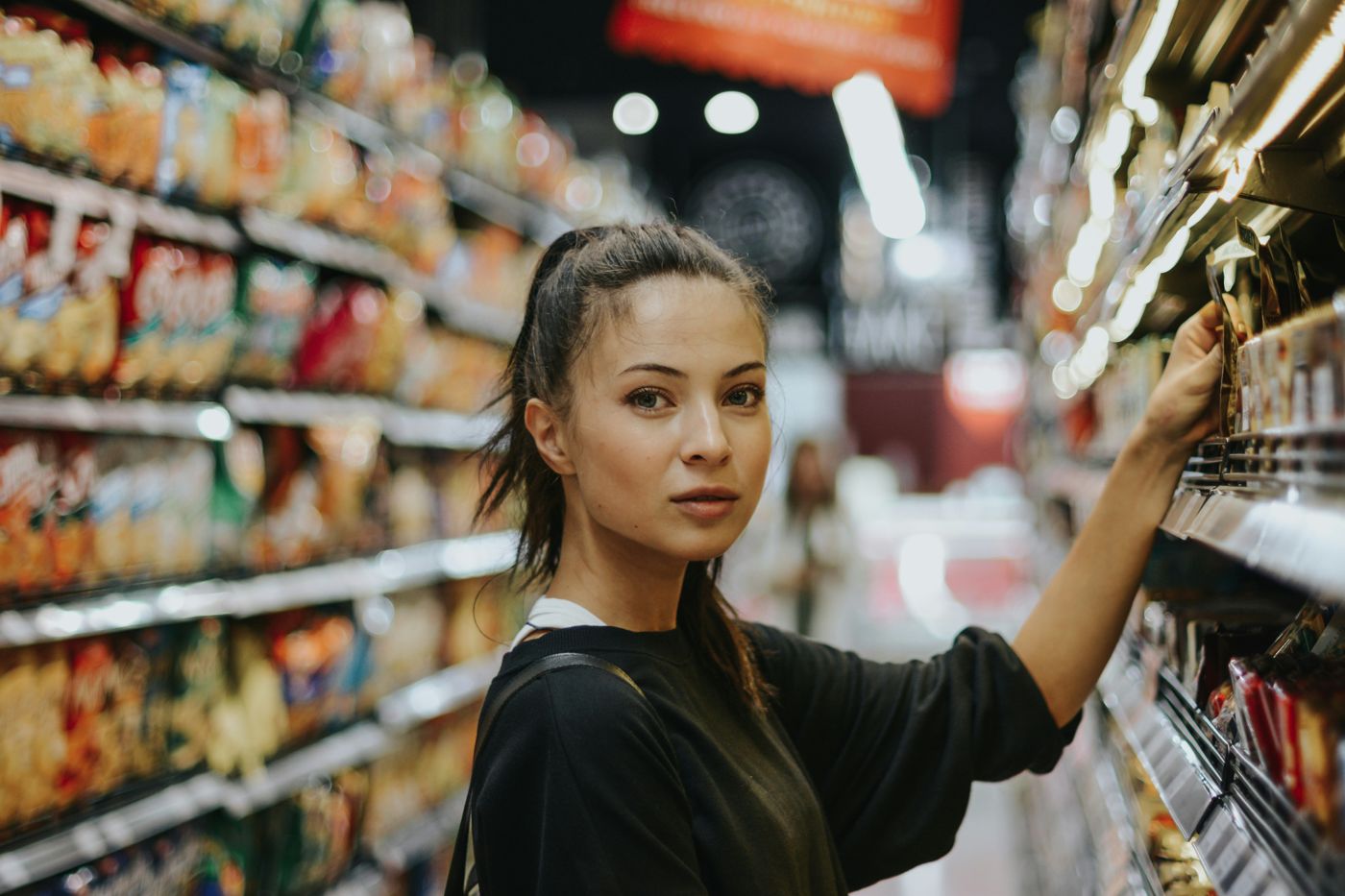 Shopper browsing the shelves in a busy store